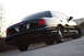 2004 Ford Crown Victoria - Rear view of a black Ford Crown Victoria P71, showing its distinctive taillights and body lines.
