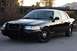 2004 Ford Crown Victoria - Front 3/4 view of a black 2004 Ford Crown Victoria P71 police car.