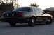 2004 Ford Crown Victoria - Rear view of a black 2004 Ford Crown Victoria sedan with tinted windows.