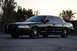 2004 Ford Crown Victoria - A black 2004 Ford Crown Victoria, likely a police interceptor model, is shown from the front three-quarter angle.