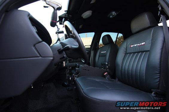 Interior of a 2004 Ford Crown Victoria police car with "GHOSTALKER" badging on the seats