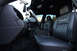 2004 Ford Crown Victoria - The interior of a 2004 Ford Crown Victoria police car, "GHOSTALKER" badging on the seats and a police console.