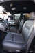 2004 Ford Crown Victoria - The interior of a police vehicle is equipped with a laptop and communication equipment.