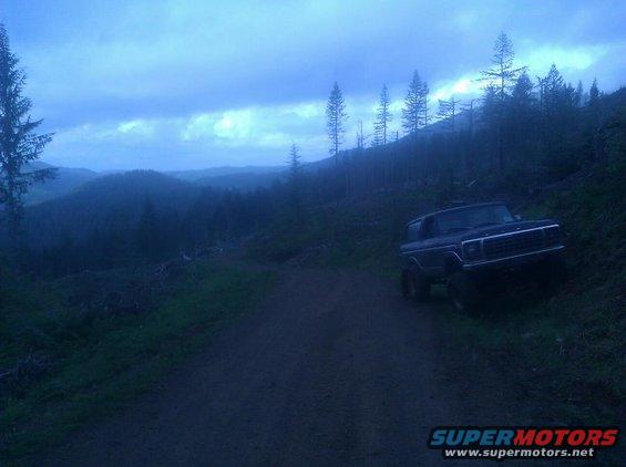 Ford Bronco parked on a dirt road on a hillside