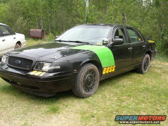 Black 2003 Ford Crown Victoria with green stripe and yellow 'BOSS' text