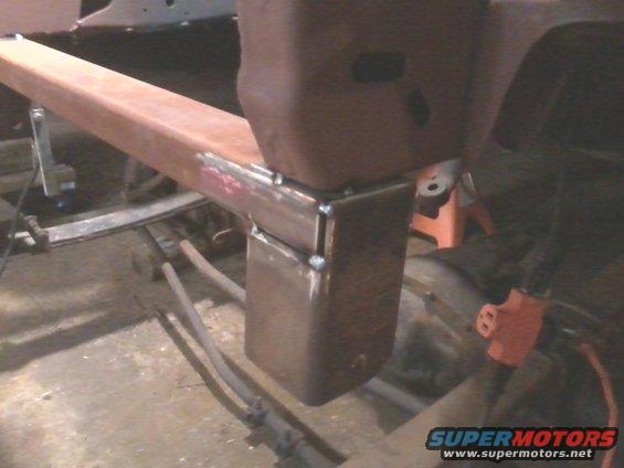 Welded steel frame section with visible welds and a red electrical connector