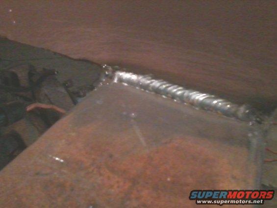 Close-up of a welded metal frame, likely part of a vehicle modification