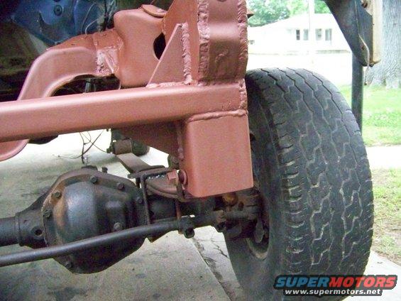 Close-up of vehicle frame with leaf spring and differential visible
