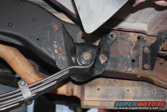 Close-up of leaf spring and frame bracket on underside of vehicle