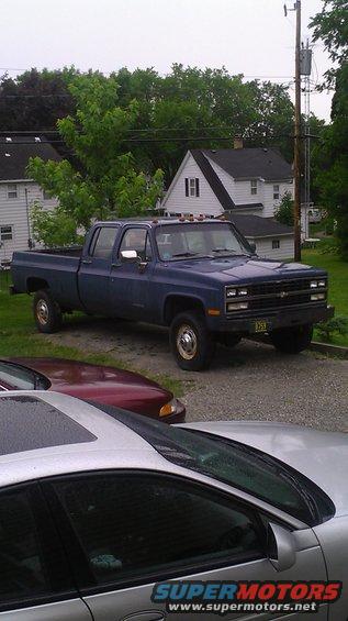 Blue 1991 Chevrolet Cheyenne crew cab pickup truck, 3q front view