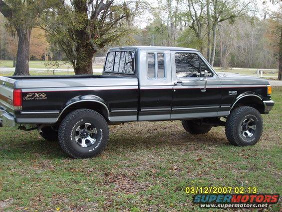 1989 Ford F-150 FX4 Off Road pickup truck, two-tone black and silver, lifted with aftermarket wheels
