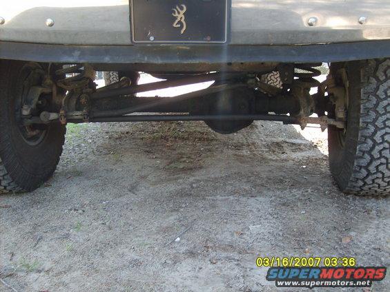 Truck rear axle and suspension with large tires and a Browning logo license plate frame