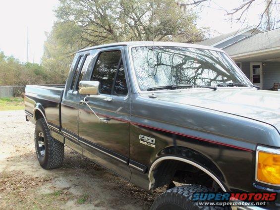 1989 Ford F-150 pickup truck, dark gray and black two-tone paint, side view