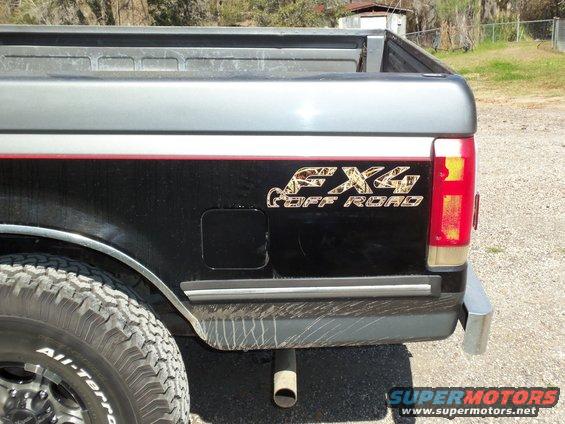 Close-up of a 1989 Ford F-150 rear quarter panel with FX4 Off Road decal and part of a tire