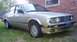 1989 BMW 3 Series - This 1989 BMW 3 Series sedan is shown from a 3/4 front angle, parked on grass next to a brick building.