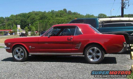 Red 1965 Ford Mustang coupe, side view, chrome wheels