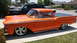 1959 Ford Ranchero - Custom 1959 Ford Ranchero features flame decals and chrome wheels, parked in a driveway with other vehicles.