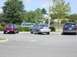 2003 Mazda 6 - A silver sedan is parked in a lot, viewed from the rear. Other vehicles are also present in the parking lot.