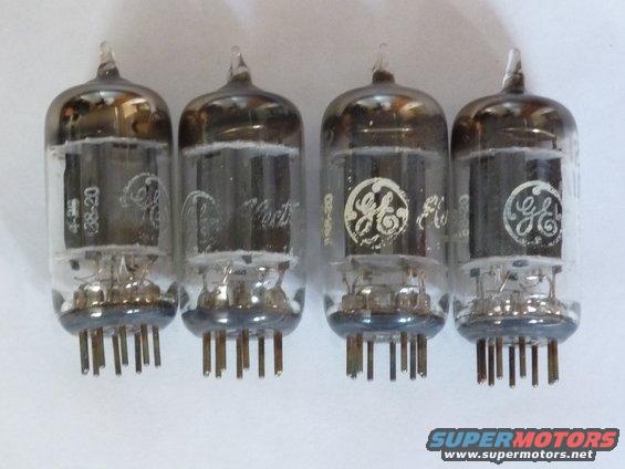 Four glass vacuum tubes with pins. Two have GE logos