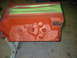 1967 Ford Mustang - An engine block, painted orange and partially masked with green tape, rests on a stand.