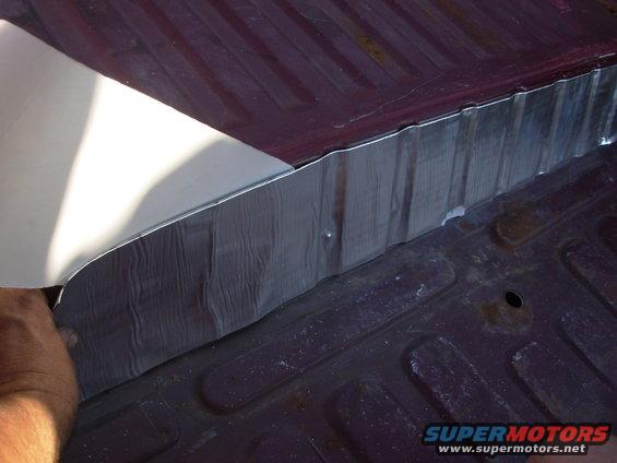 133pnsm.jpg By leaving the backing on & holding tension where the strip goes, it's easier to place it in all the corrugations.