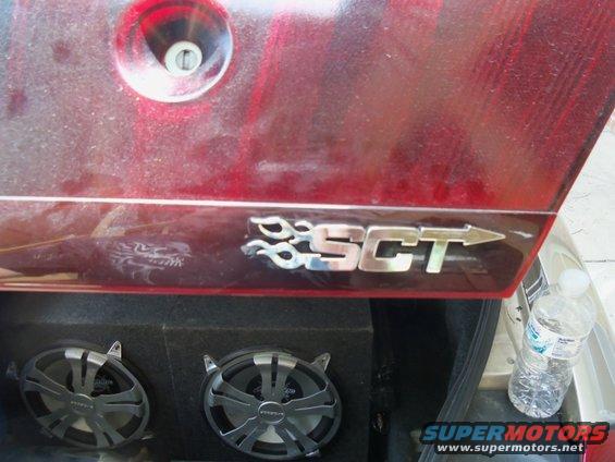 Red car trunk with SCT badge and speakers