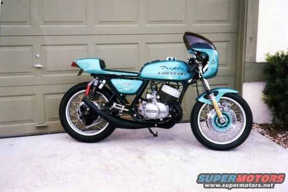 Light blue Kawasaki motorcycle with fairing and "Triple KAWASAKI 750" text