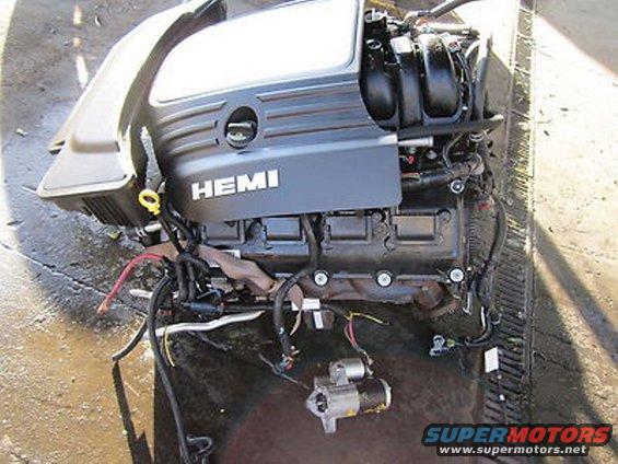 Engine with HEMI branding, detached starter motor, and wiring harness