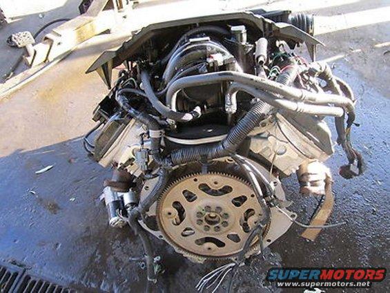 Engine assembly with transmission bell housing and flywheel visible