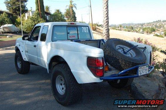 1999 Ford Ranger pickup truck with off-road tires, spare tire in bed, and custom rear bumper