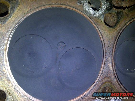 Engine cylinder head with two valves and carbon buildup