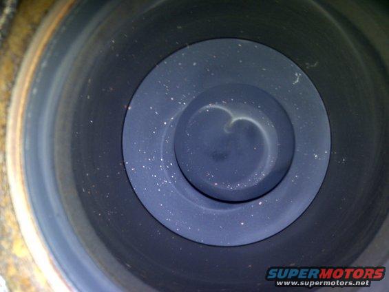Engine cylinder interior with carbon buildup and visible valve imprint