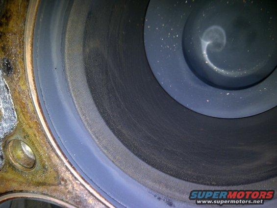 Close-up of an engine cylinder with visible scoring and carbon buildup