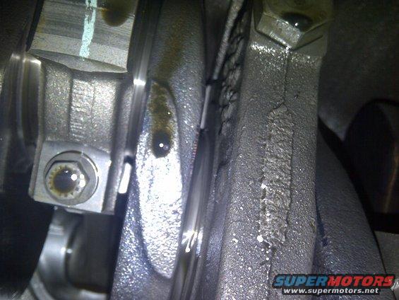 Close-up of engine crankshaft and connecting rod with oil