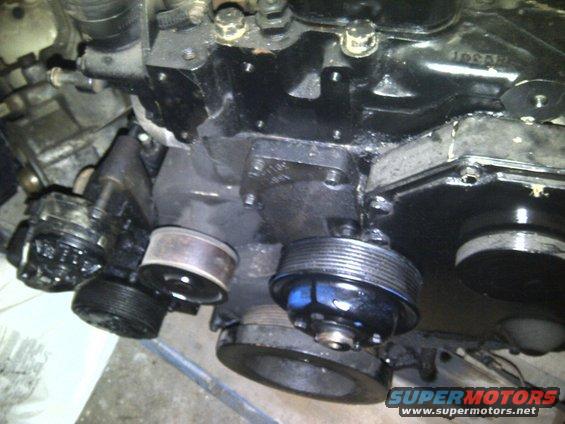 Close-up of engine pulleys and black engine block