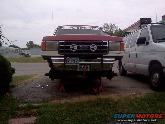 1989 Ford Bronco front view on jack stands, red with "WEEKEND 4 WHEELERS" sticker