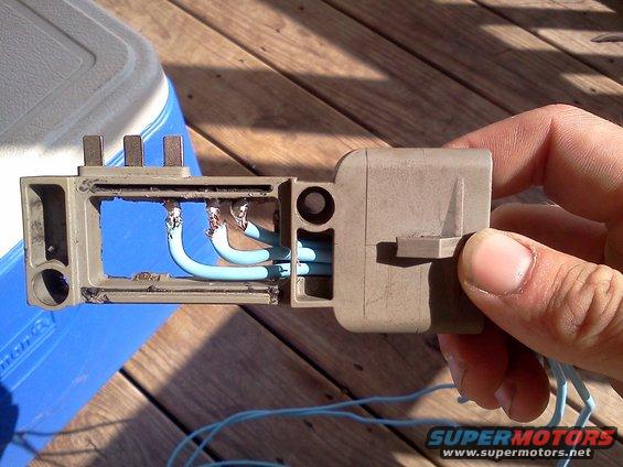 Electrical connector with blue wires being held by a hand