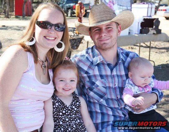 Family with two young children at an outdoor gathering