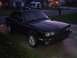 1991 BMW 3 Series - Black 1991 BMW 3 Series sedan seen from a 3/4 front angle in a residential driveway.