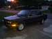 1991 BMW 3 Series - A dark sedan sits in a driveway as evening approaches, with a street light illuminating the scene.
