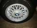 1991 BMW 3 Series - A close-up view of a BMW wheel and tire, showing the intricate design of the alloy rim and the brand's emblem.