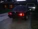 1991 BMW 3 Series - A dark BMW 325i is parked in a driveway, with another vehicle visible behind it.