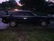 1991 BMW 3 Series - A black 1991 BMW 3 Series sedan is parked on a residential street at dusk.