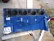 1967 Ford Mustang - V8 engine block painted blue, mounted on a stand for rebuilding or display.