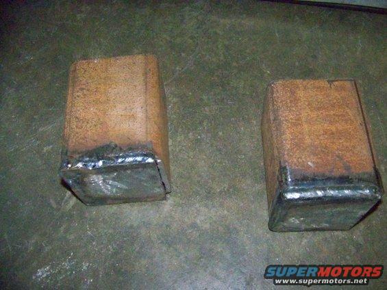 Two welded metal blocks with rust and weld marks