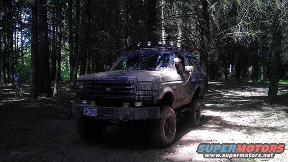 1995 Ford Bronco in woods, 3q-front view, dirty exterior
