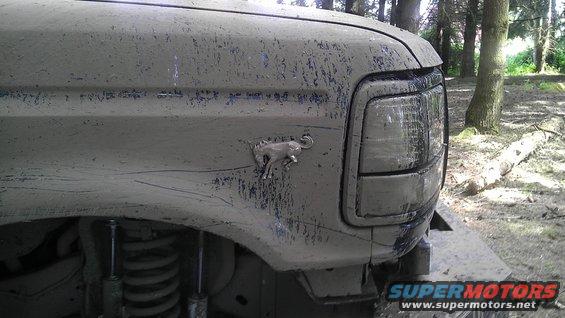 Mud-covered 1995 Ford Bronco fender with running horse emblem visible