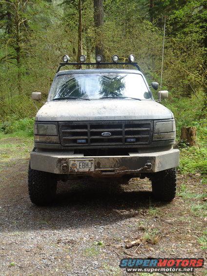 1995 Ford Bronco front view, dirty, with aftermarket bumper and light bar