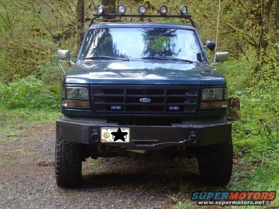 Dark green 1995 Ford Bronco front view with aftermarket bumper and roof lights