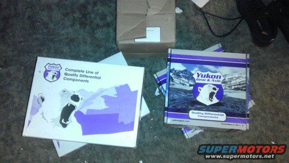 Two Yukon Gear & Axle boxes with polar bear logos and mountain graphics sit on a carpeted floor